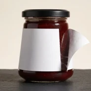 Why labels peel off bottles at the edges, shown on a tapered glass food jar